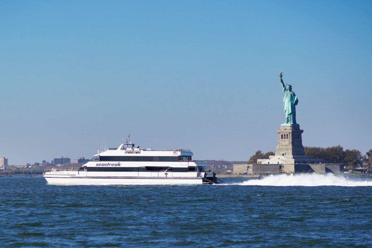 A Seastreak ferry passing the Statue of Liberty in New York Harbor