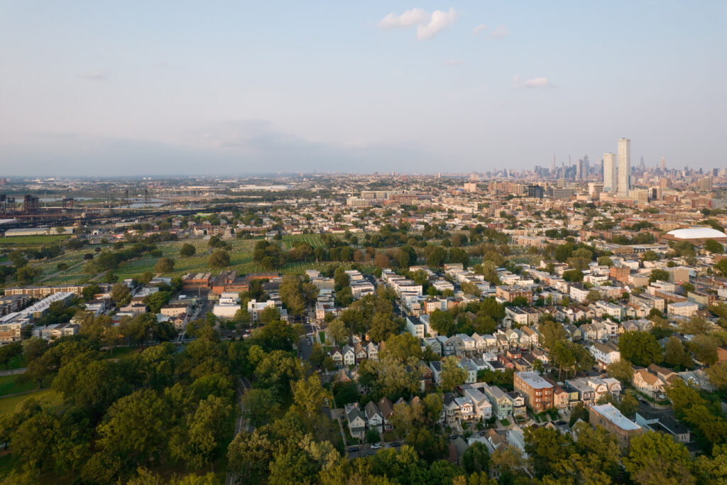 An aerial view of Jersey City, New Jersey neighborhoods with the Manhattan skyline visible in the background