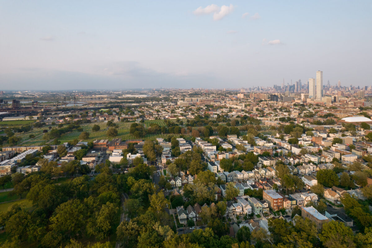 An aerial view of Jersey City, New Jersey neighborhoods with the Manhattan skyline visible in the background