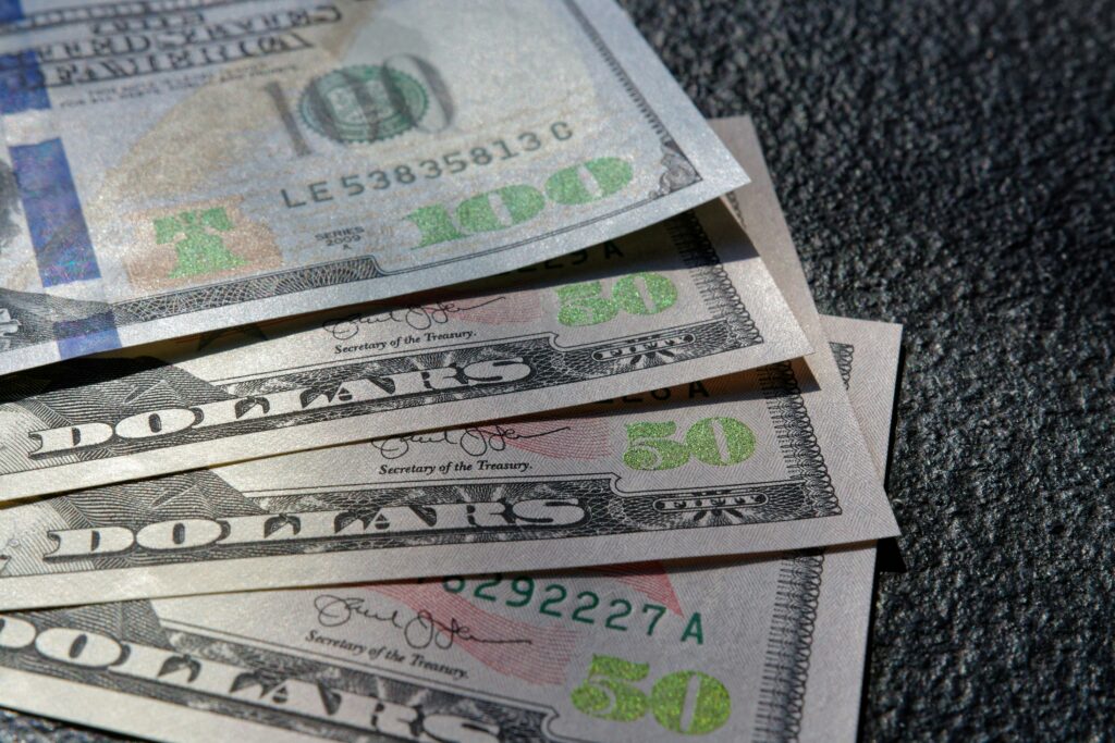 U.S. currency fanned out representing consumer costs and hidden junk fees