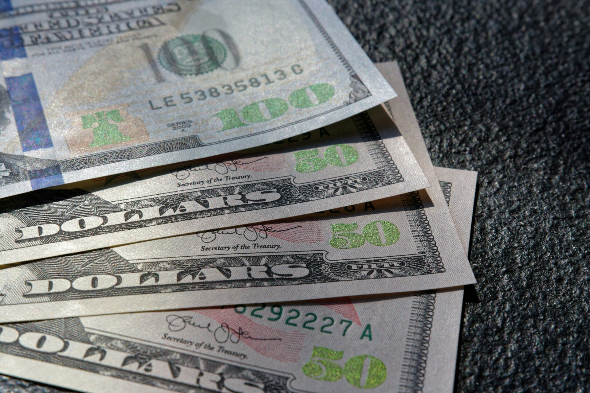 U.S. currency fanned out representing consumer costs and hidden junk fees