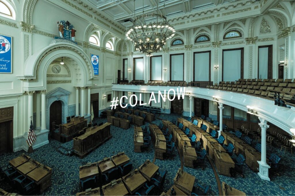 The New Jersey General Assembly chamber in Trenton with the #COLANow hashtag overlaid, representing the push to restore cost-of-living adjustments for public retirees