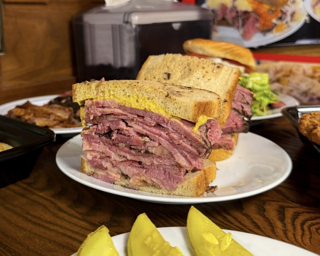 A pastrami on rye sandwich with pickles at Pastrami Grill Bistro in Garfield, New Jersey