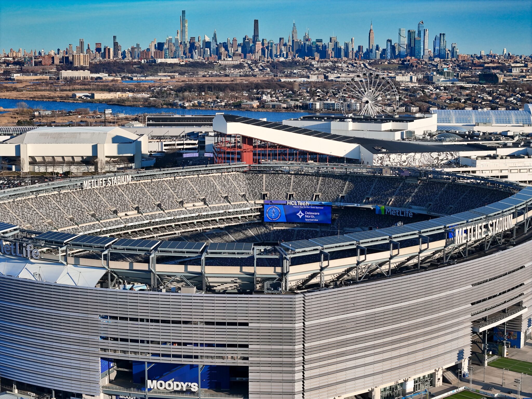Aerial view of MetLife Stadium in East Rutherford, New Jersey with the Manhattan skyline in the background