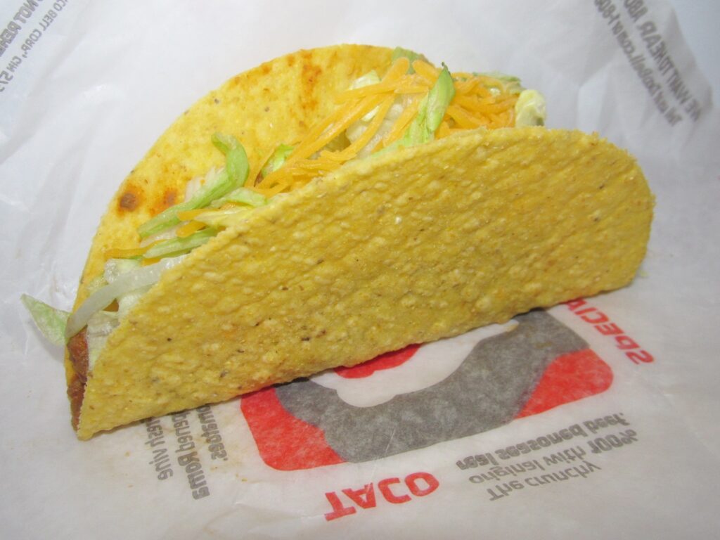 a taco bell hard shell taco with lettuce