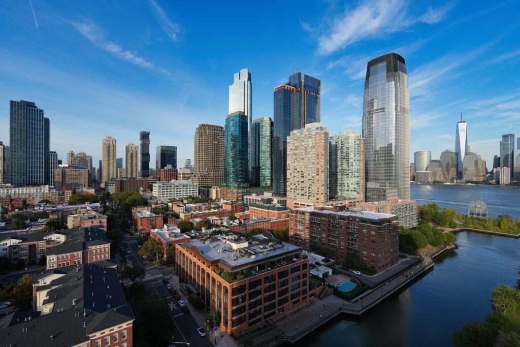 The Jersey City skyline along the Hudson River, home to dozens of Greystar-managed apartment buildings.