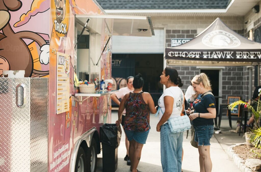 Customers line up at a colorful food truck outside Ghost Hawk Brewing in New Jersey