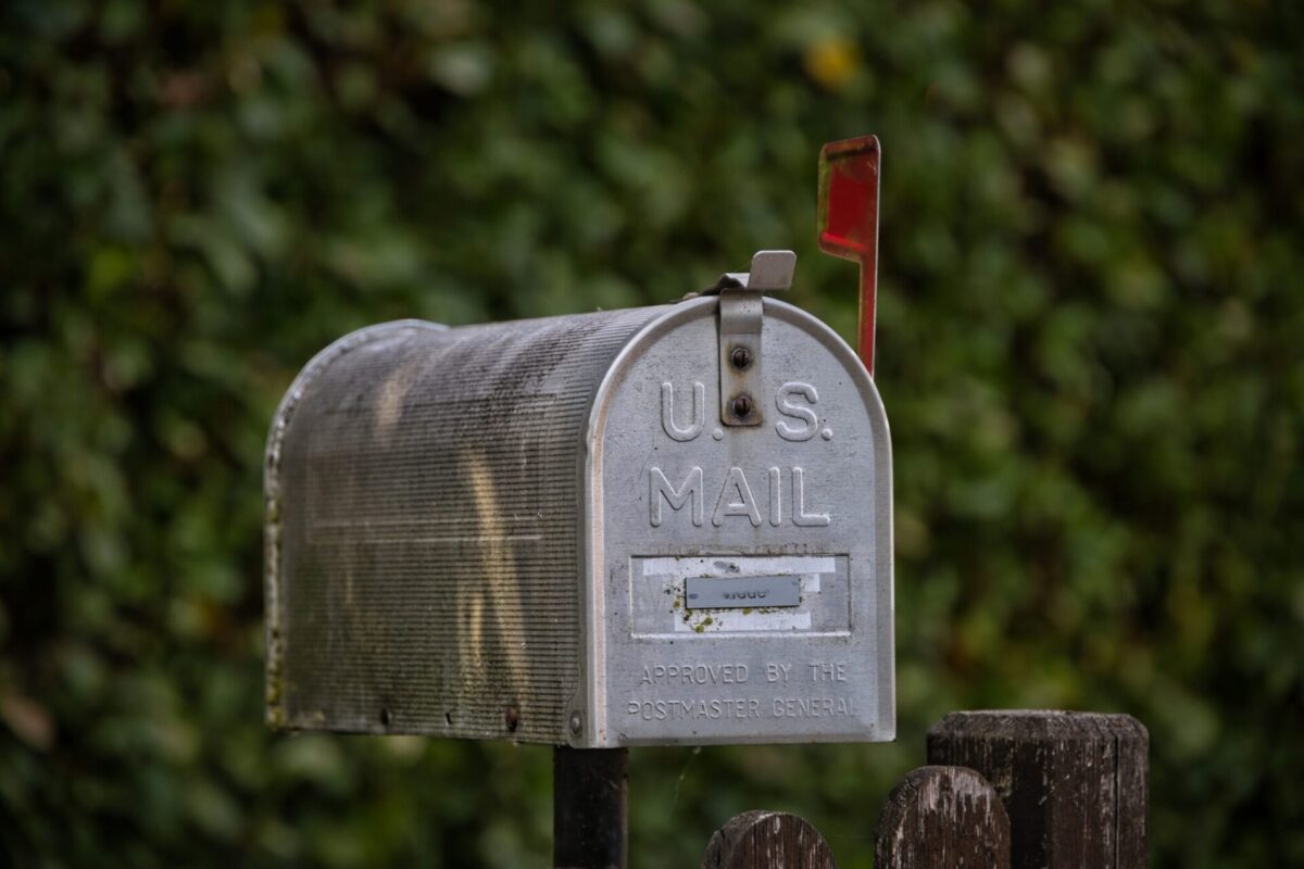 A U.S. Mail mailbox with the flag raised, representing New Jersey Senior Freeze checks arriving by mail.