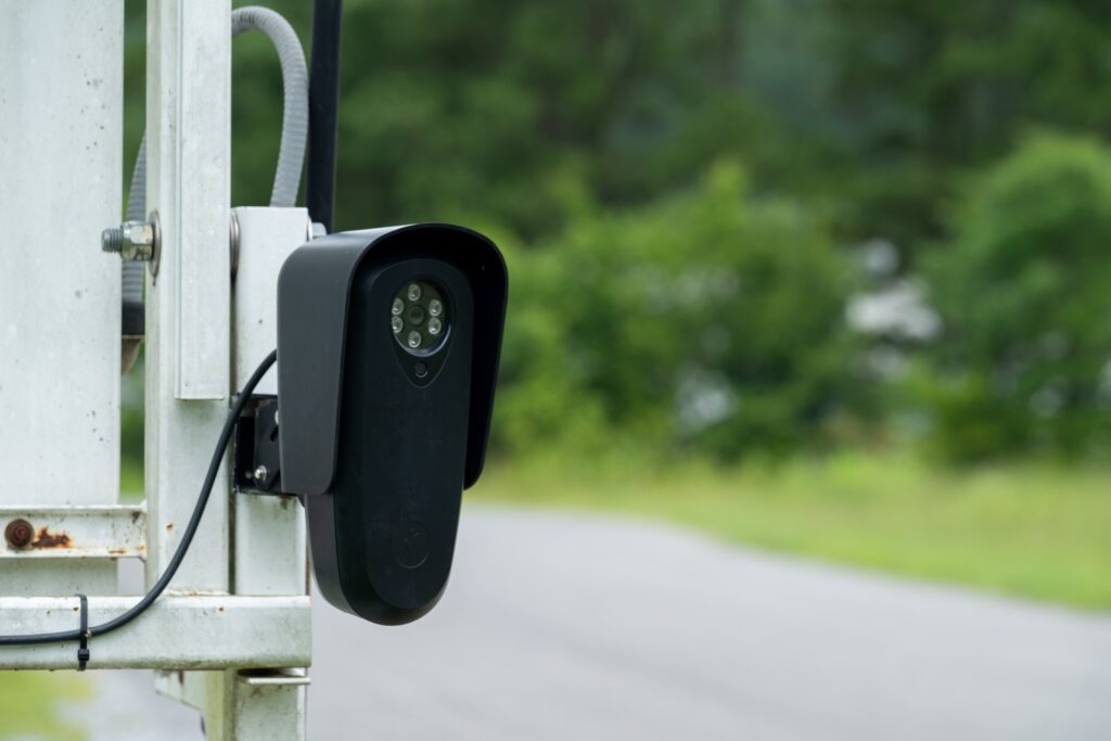 A Flock Safety license plate reading camera mounted on a roadside trailer