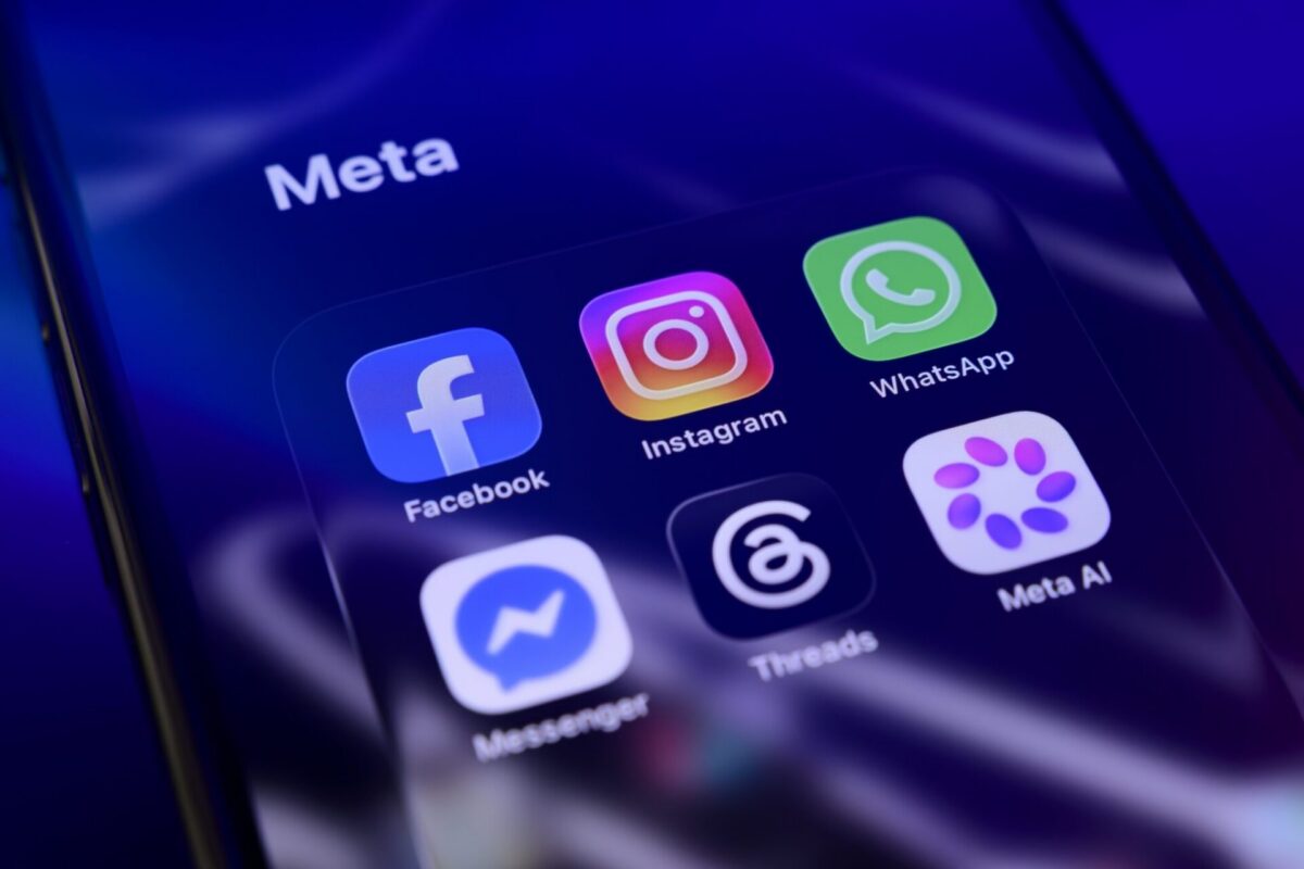 A smartphone screen showing Meta's app folder, including Facebook and Instagram, the platforms at the center of the multistate settlement