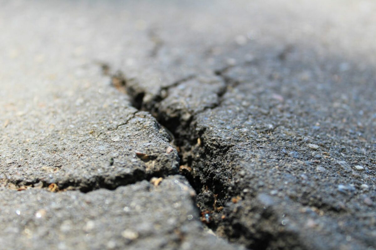 A cracked road surface, representing the fractured "immature" fault structure discovered beneath New Jersey