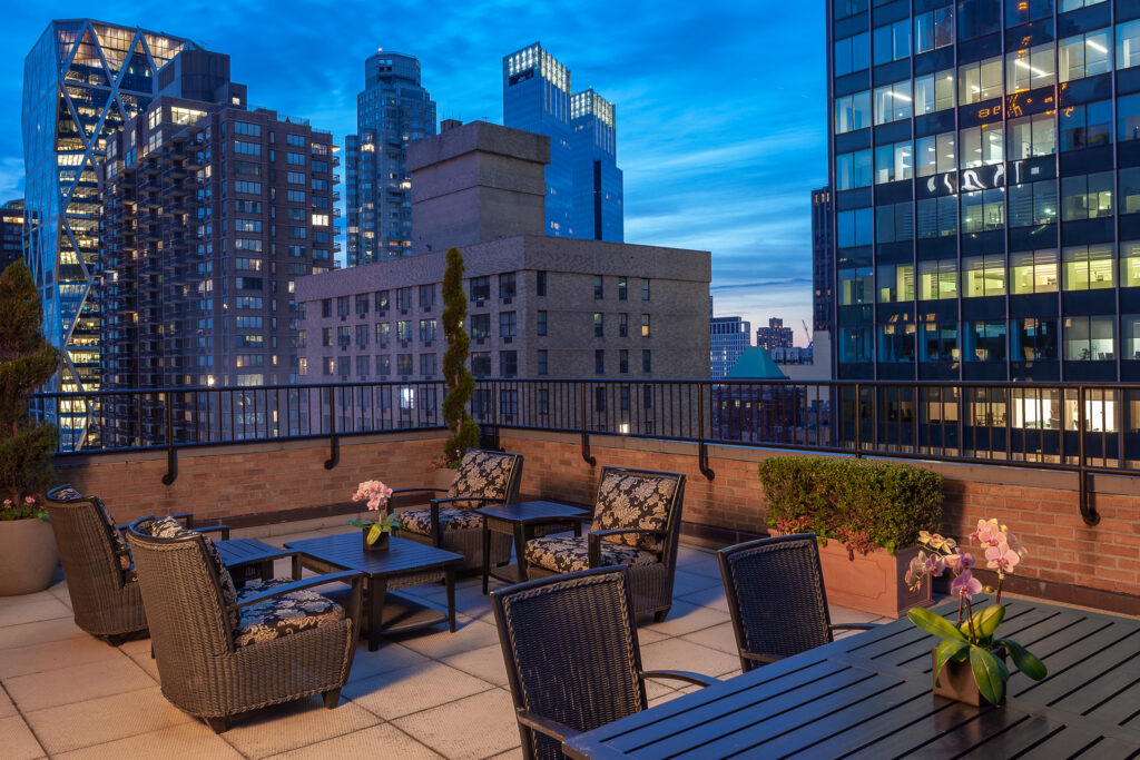 An outdoor terrace at night at the manhattan club