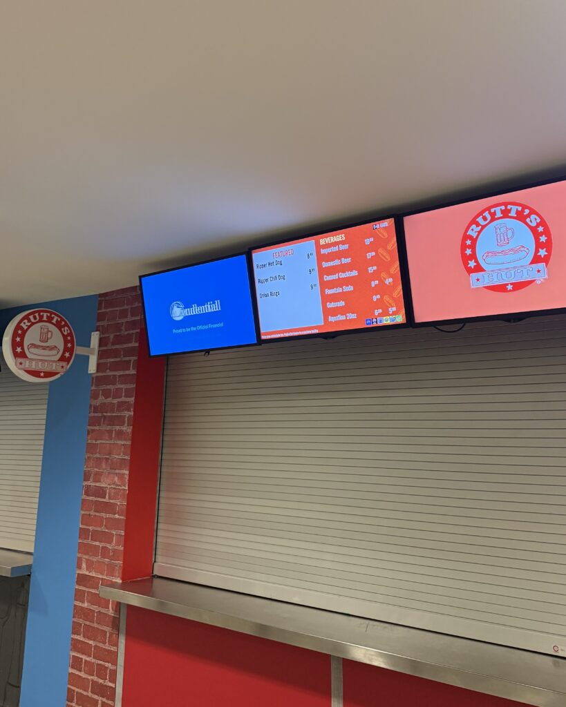The Rutt's Hut stand at Prudential Center, showing a TV menu with items listed